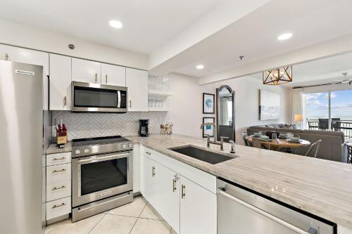 a kitchen with a sink and a stove top oven at HP 23W Calypso Crossing by 30A Escapes in Rosemary Beach