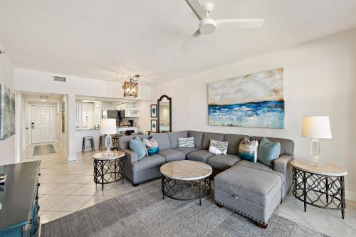 a living room with a couch and two tables at HP 23W Calypso Crossing by 30A Escapes in Rosemary Beach