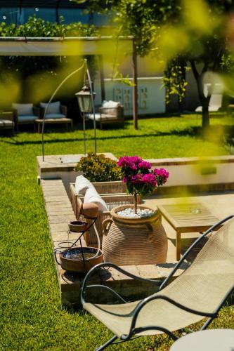 a couple of chairs and a table and some flowers at B&B PROCHYTEA in Procida