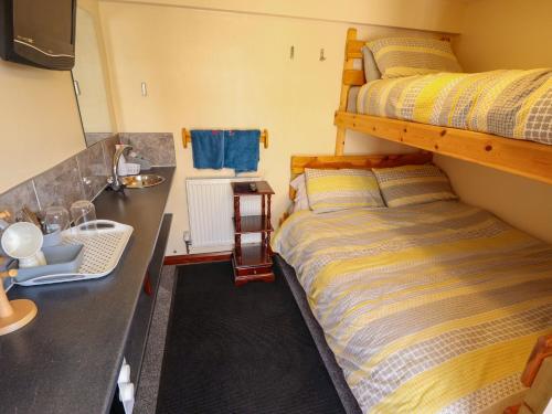 a bedroom with a bunk bed next to a counter at Lancaster in Lincoln