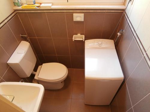 a small bathroom with a toilet and a sink at Apartment studio Mia-beach in Split in Split