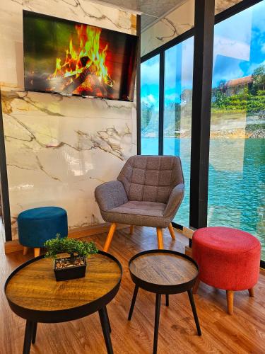 a living room with a couch and two chairs and tables at Eden Hotel in El Peñol