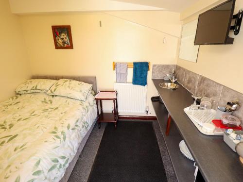 a small bedroom with a bed and a sink at Dakota in Lincoln