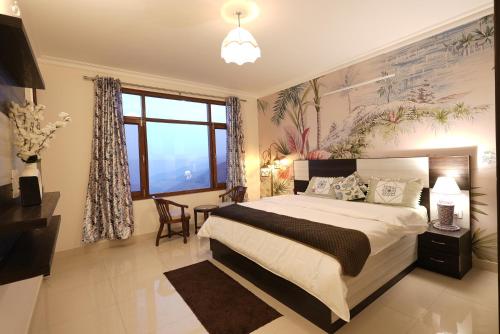 a bedroom with a bed and a desk and a window at Wandernest Homes Casa Da Flora in Mashobra