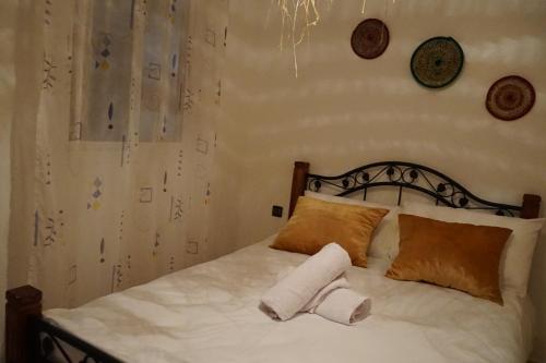 a bedroom with a bed with two towels on it at Heaven Surf House Private Group Stay Sleeps 24 in Tamraght Ouzdar