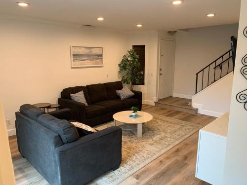 a living room with a couch and a table at Beautifully Remodeled 2BR Prime Irvine Location in Irvine