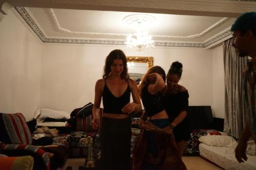 a group of three women standing in a living room at Heaven Surf House Private Group Stay Sleeps 24 in Tamraght Ouzdar