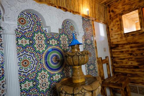 a room with a wall covered in colorful tiles at Heaven Surf House Private Group Stay Sleeps 24 in Tamraght Ouzdar