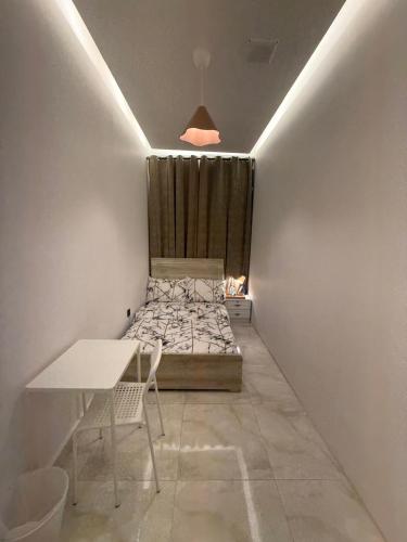 a small room with a bed and a table at Emira Property in Abu Dhabi