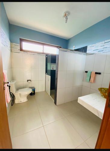 a bathroom with a toilet and a sink at Pousada Destino in Porto de Sauipe