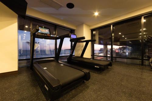 a gym with two treadmill machines in a room with windows at Holiday Inn Express & Suites Mazatlan by IHG in Mazatlán