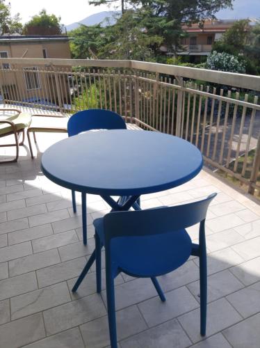 a blue table and two chairs on a patio at La Maison Verte in Formia