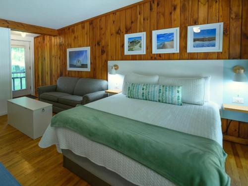 a bedroom with a large bed and a couch at Dune Climb Inn in Empire