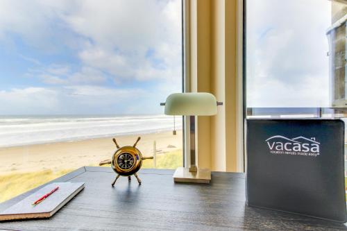 a room with a clock on the floor next to a beach at Romantic Manhattan Beach Sunset #202 in Rockaway Beach