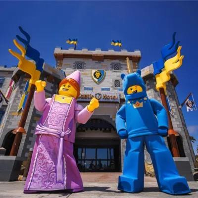 two lego characters standing in front of a building at LEGOLAND California Hotel and Castle Hotel in Carlsbad
