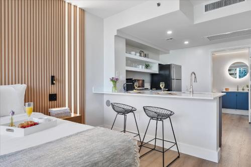 a kitchen and living room with a bed and a counter at Private Oasis at Arya in Miami