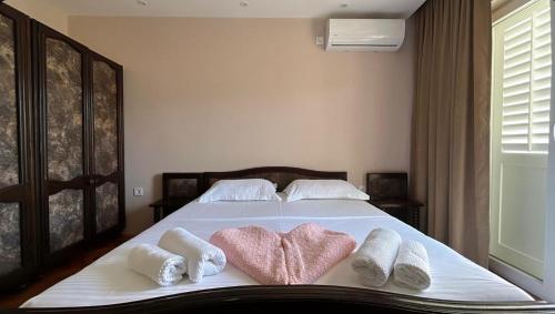 a bedroom with a bed with towels on it at Josipović Cozy Stay Apartments in Igalo