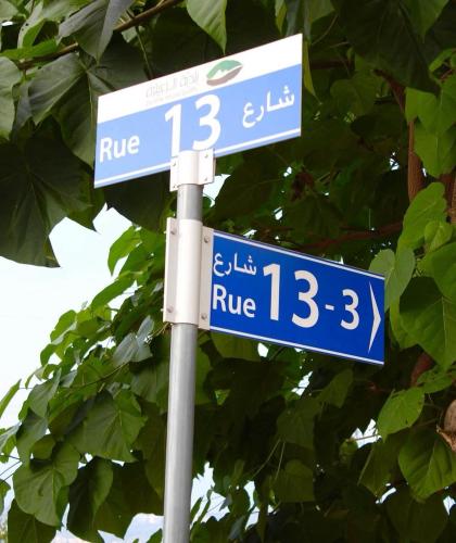 two blue street signs on top of a pole at Guesthouse in a countryside 