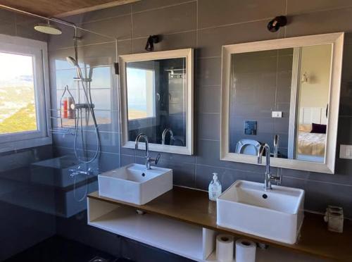 a bathroom with two sinks and two mirrors at Guesthouse in a countryside 