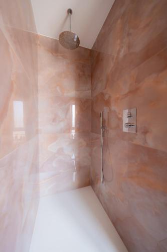 a bathroom with a shower with a stone wall at Charleroi Airport House 3 chambres & Parking in Charleroi