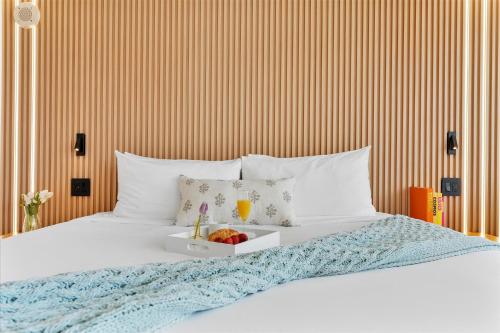 a bed with a tray of fruit on it at Private Oasis at Arya in Miami