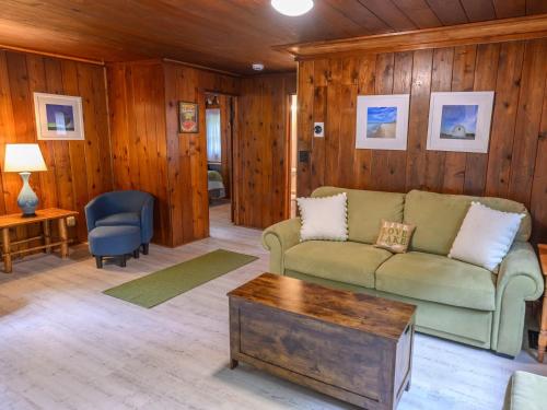 a living room with a couch and a table at Dune Climb Inn in Empire