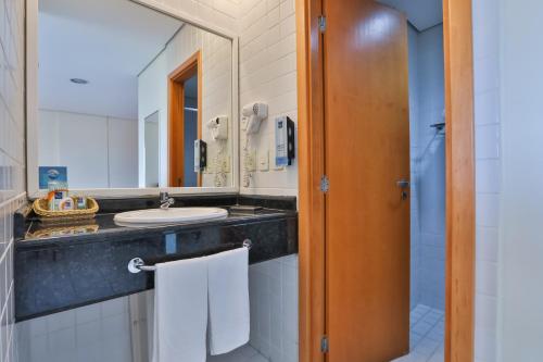 a bathroom with a sink and a mirror at Sleep Inn Manaus in Manaus