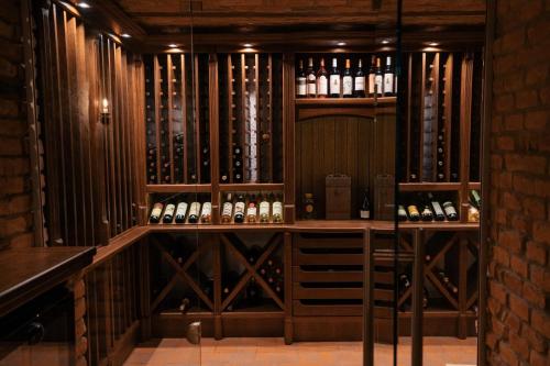 a room with a bunch of bottles of wine at Strindberg Boutique Hotel in Topliţa