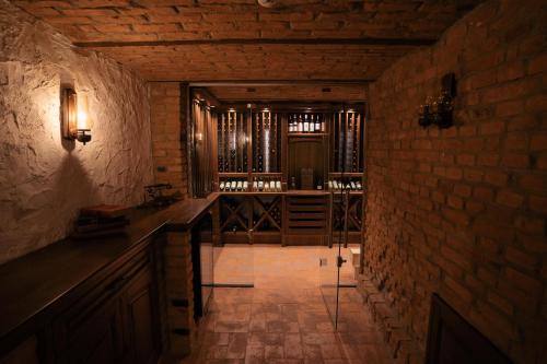 a dark room with a bar and a brick wall at Strindberg Boutique Hotel in Topliţa