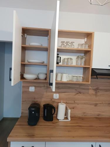a kitchen with a cupboard with dishes on it at minimalistic in Żory