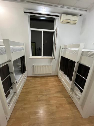 a room with two bunk beds and a window at FRIENDS Hostel Baku in Baku