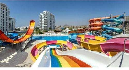 a water park with a colorful water slide at Апартаменты в комплексах Цезарь Бич и Цезарь Блю in Boğaz