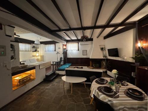 a room with two tables and a kitchen in a restaurant at Vintage Studio - Great for Travelers in Transit in Koropíon