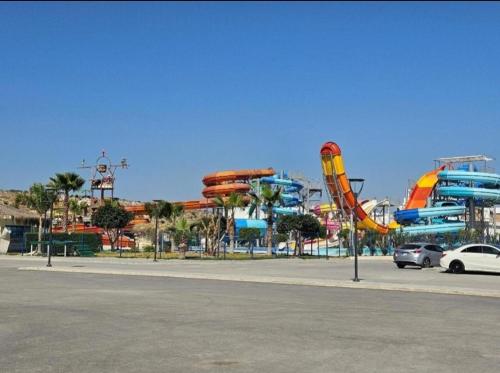 a large water park with a roller coaster at Апартаменты в комплексах Цезарь Бич и Цезарь Блю in Boğaz