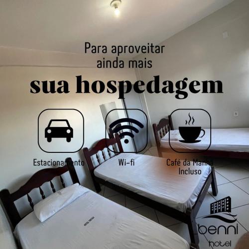 a room with two beds and signs on the wall at Benni Hotel Marabá in Marabá