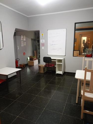 a room with a white wall and a white board at Hospedaria Casa373 valores acessíveis Vila Mariana e Vila Clementino in Sao Paulo