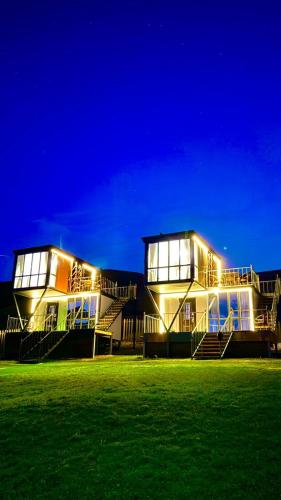 a large building with lights on at night at Opensky-kolsai in Saty