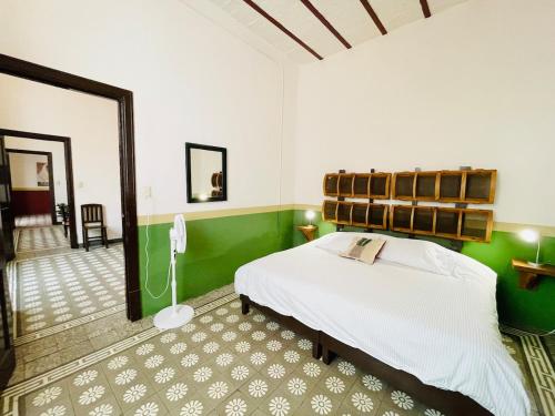 a bedroom with a bed and a phone in it at Departamento #8 frente al Zócalo de Puebla en casona del siglo XVI in Puebla