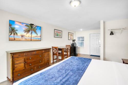 a bedroom with a large bed with a blue rug at Coconut Cay Resort in Marathon
