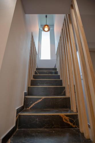 a staircase in a building with a window at Serenity Karditsa Lofts in Kardítsa