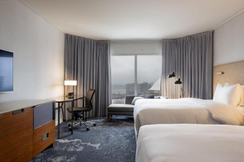 a hotel room with two beds and a desk at InterContinental Toronto Centre by IHG in Toronto