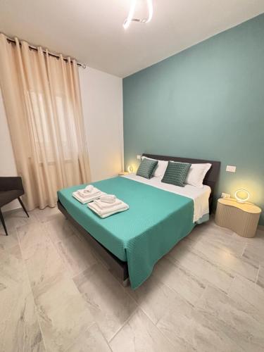 a bedroom with a large bed with a blue blanket at Il Castagno in Vasto