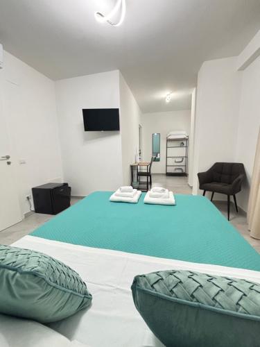 a bedroom with two beds and a room with a tv at Il Castagno in Vasto