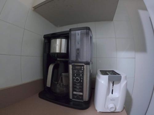 a kitchen with a coffee maker and a blender at Ocean View, Pool, Gym, Basketball Court, Wifi in Cabo Rojo