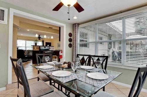 a dining room with a glass table and chairs at Great Shape After Milton -gorgeous Pool! - Os in Venice