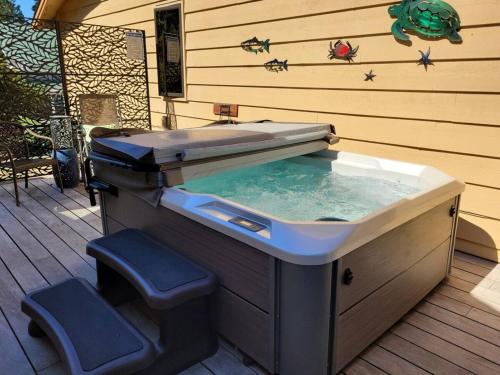 a hot tub sitting on a deck with aitating at 3 Bed Gorgeous Views Hot Tub Dog Friendly Ada in Langley