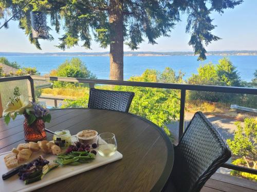 a plate of food sitting on a table on a balcony at 3 Bed Gorgeous Views Hot Tub Dog Friendly Ada in Langley