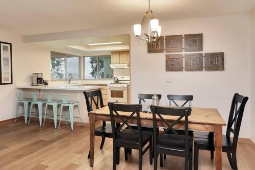 a kitchen and dining room with a wooden table and chairs at 3 Bed Gorgeous Views Hot Tub Dog Friendly Ada in Langley