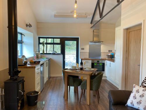 a kitchen with a wooden table and a kitchen with a stove at Sun Valley Retreat in Milton