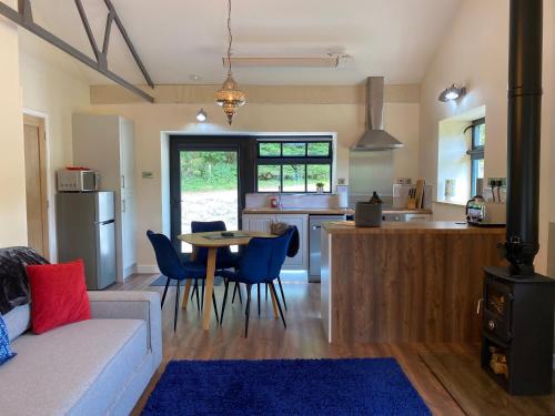 a living room and kitchen with a table and chairs at Sun Valley Retreat in Milton